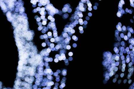 The circular blue light bokeh on dark blackground.