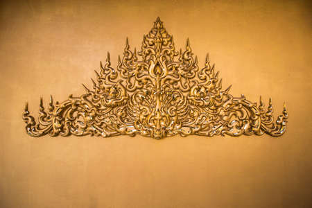 Gold stucco Thai style on golden background.の写真素材