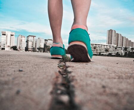 young fitness woman hiker legs on streetの写真素材