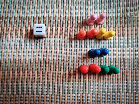 Bunch of colorful game board pieces isolated on matの写真素材