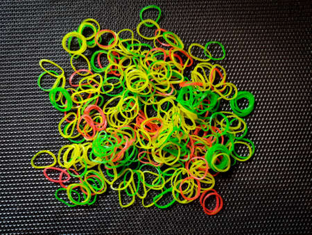 Bunch of color rubber bands isolated on black background.