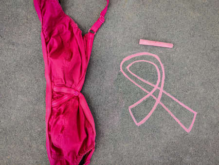 Chalk drawing of Breast Cancer Awareness Ribbon and bra on grey backgroundの写真素材