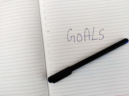 A Daily diary with text GOALS and pen.