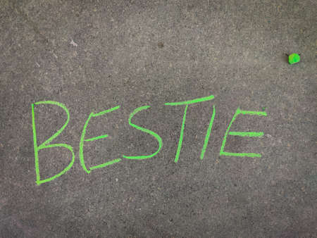 The inscription text on the grey board, Bestie. Using color chalk pieces.の写真素材