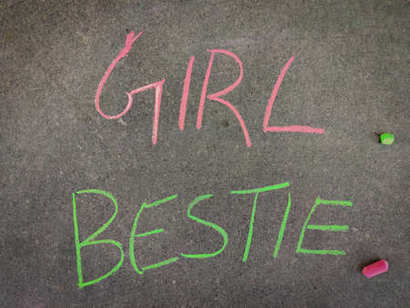 The inscription text on the grey board, girl Bestie. Using color chalk pieces.の写真素材