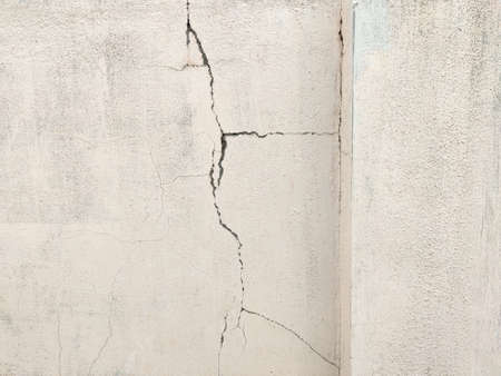 Cracked concrete white wall texture. Old apartment.の写真素材