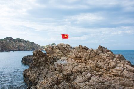 Vietnam flaf on the rock Quy Nhon beachの写真素材