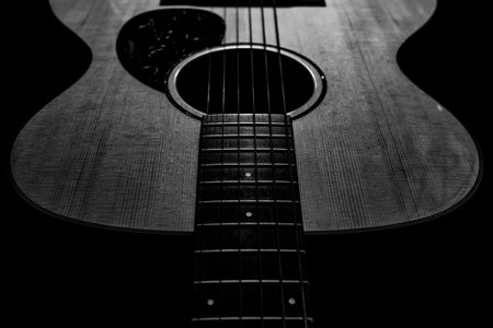 Acoustic guitar on a black background. Close-up. Black and white.の写真素材