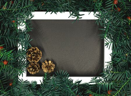 Creative layout made from Christmas tree branches with red berries and frame paper card note. Copy space for text. Nature New Year conceptの写真素材