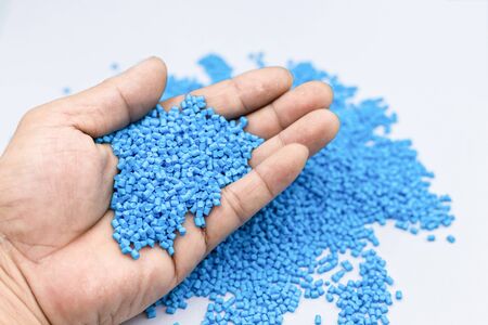 Blue color Plastic beads in holding hand, Production of recyle polypropilene for industrialの写真素材
