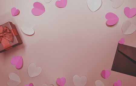 Paper elements in shape of heart flying on pastel pink background, Valentine's Day and lovely concept, copy space for note and textureの写真素材