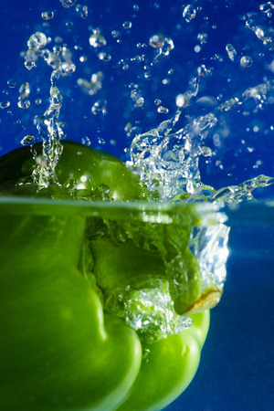 Colorful sweet pepper drops in waterの写真素材