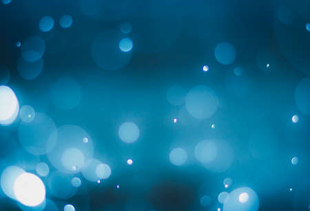 abstract gradient blue background with bokeh light effectの写真素材