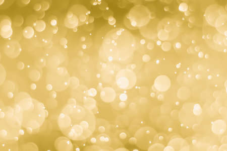 abstract golden background with light bokeh effectの写真素材
