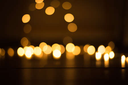 abstract gold bokeh light effect with dark backgroundの写真素材