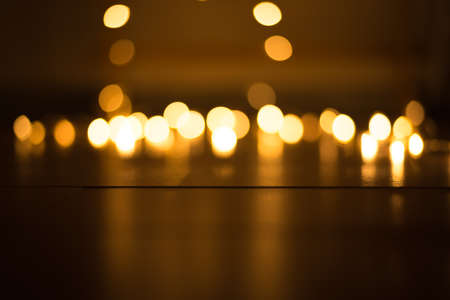 abstract gold bokeh light effect with dark backgroundの写真素材