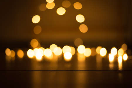 abstract gold bokeh light effect with dark backgroundの写真素材