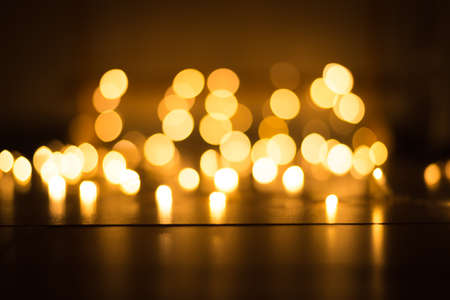 abstract gold bokeh light effect with dark backgroundの写真素材