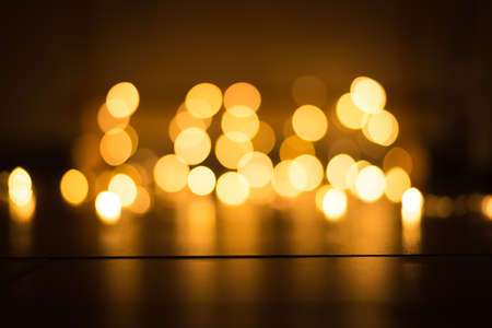 abstract gold bokeh light effect with dark backgroundの写真素材