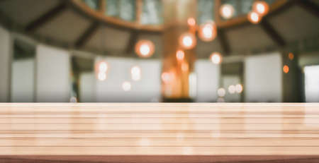 Empty wooden table top with lights bokeh on blur restaurant background, 3D Renderingの写真素材