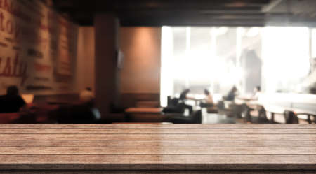 Wooden top table with bokeh light effect and blur restaurant on background, blur backgroundの写真素材
