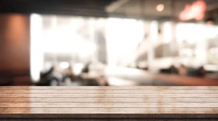 Wooden top table with bokeh light effect and blur restaurant on background, blur backgroundの写真素材