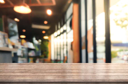 Empty wooden table top with lights bokeh on blur restaurant background