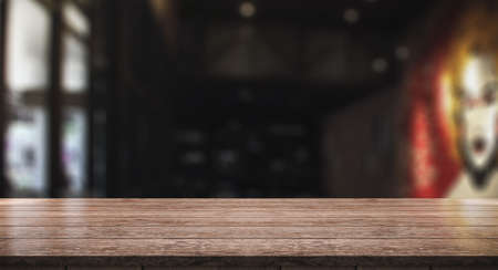 Empty wood table with blur vintage restaurant background.