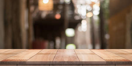 Empty wood table with blur vintage restaurant background.の写真素材