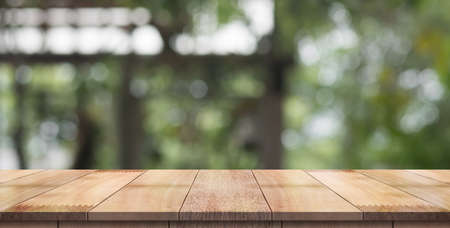 Empty wood table with blur vintage restaurant background.
