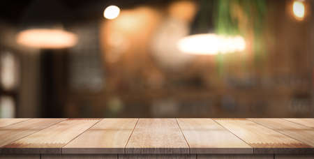 Empty wood table with blur vintage restaurant background.の写真素材