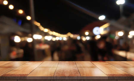 Empty wood table on blur night market background.の写真素材