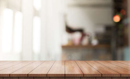 Empty wooden table top with lights bokeh on blur restaurant background.