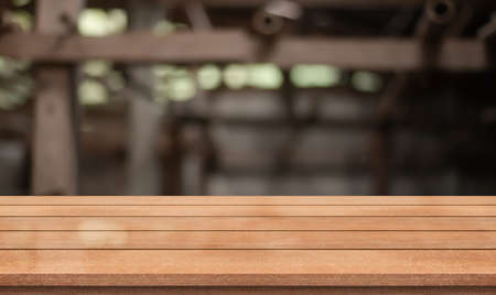 Empty wooden table top with lights bokeh on blur restaurant background.の写真素材
