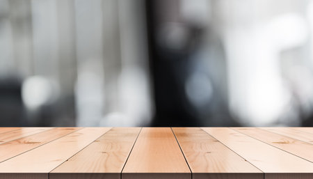 Empty wooden table top with lights bokeh on blur restaurant backgroundの写真素材