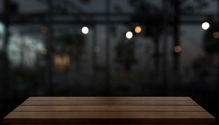 Empty wooden table top with lights bokeh on blur restaurant background.の写真素材