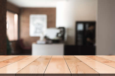 Empty wooden table top with lights bokeh on blur restaurant background.の写真素材