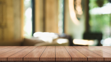 Empty wooden table top with lights bokeh on blur restaurant background.の写真素材