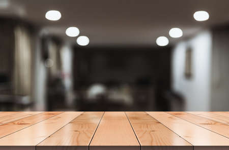 Empty wooden table top with lights bokeh on blur restaurant background.