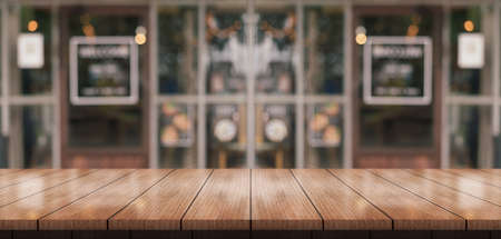 Empty wooden table top with lights bokeh on blur restaurant background.の写真素材