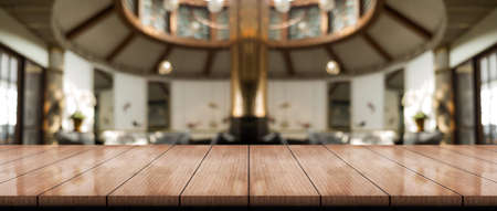 Empty wooden table top with lights bokeh on blur restaurant background.の写真素材