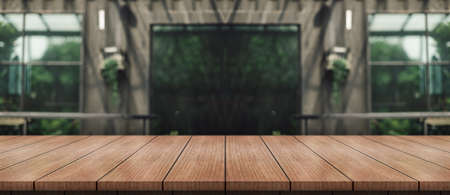 Empty wooden table top with lights bokeh on blur restaurant background.の写真素材