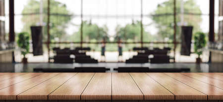 Empty wooden table top with lights bokeh on blur restaurant background.の写真素材