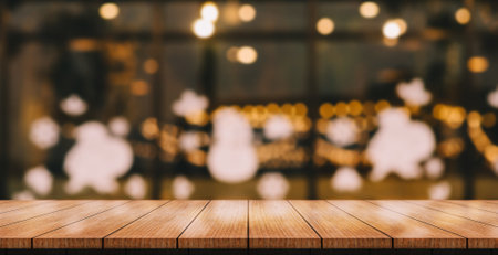 Empty wooden table top with lights bokeh on blur restaurant background.の写真素材