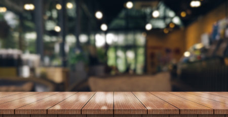 Empty wooden table top with lights bokeh on blur restaurant background.