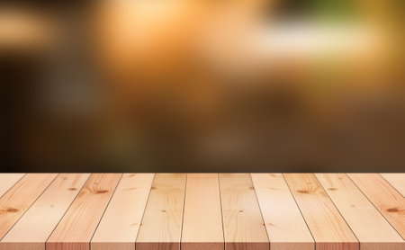 Empty wooden table top with lights bokeh on blur restaurant background.の写真素材
