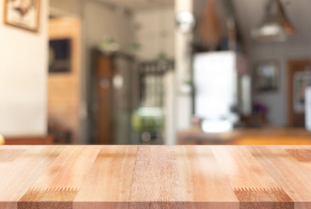 Empty wooden table top with lights bokeh on blur restaurant background.の写真素材