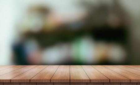Empty wooden table top with lights bokeh on blur restaurant background.の写真素材