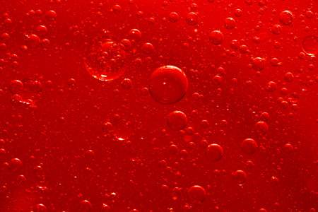 Water bubble texture on red backgroundの写真素材