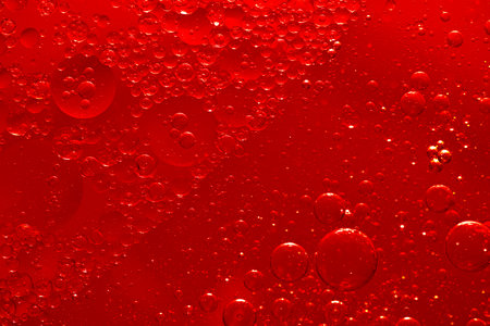 Water bubble texture on red backgroundの写真素材